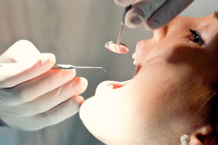Friendly dentists perform a routine check-up in peterborough